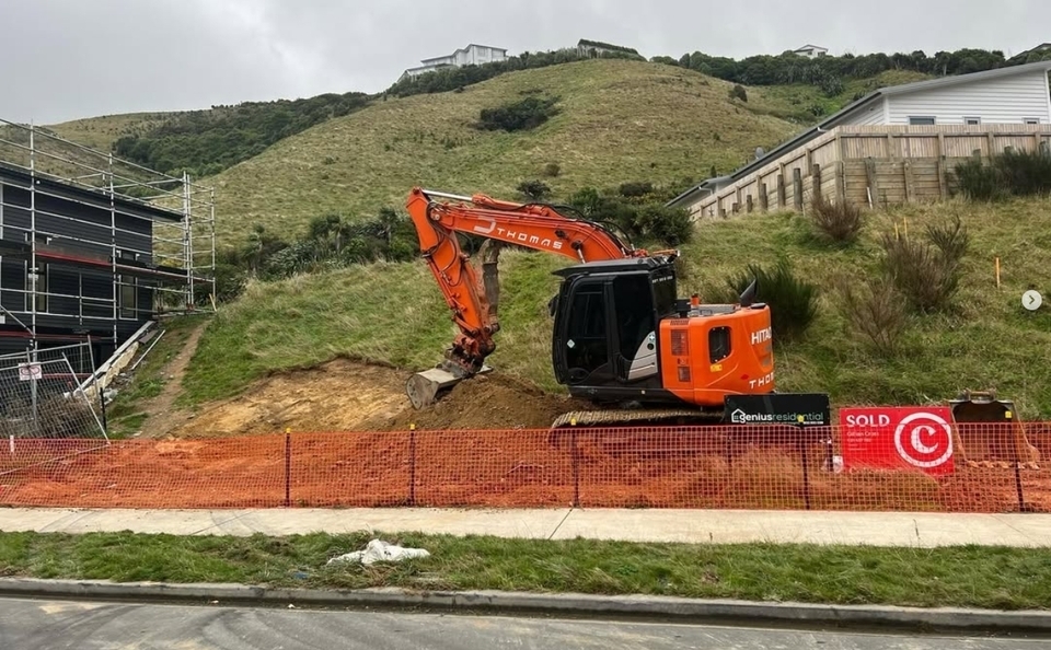 Excavator working on a steep Wellington residential site